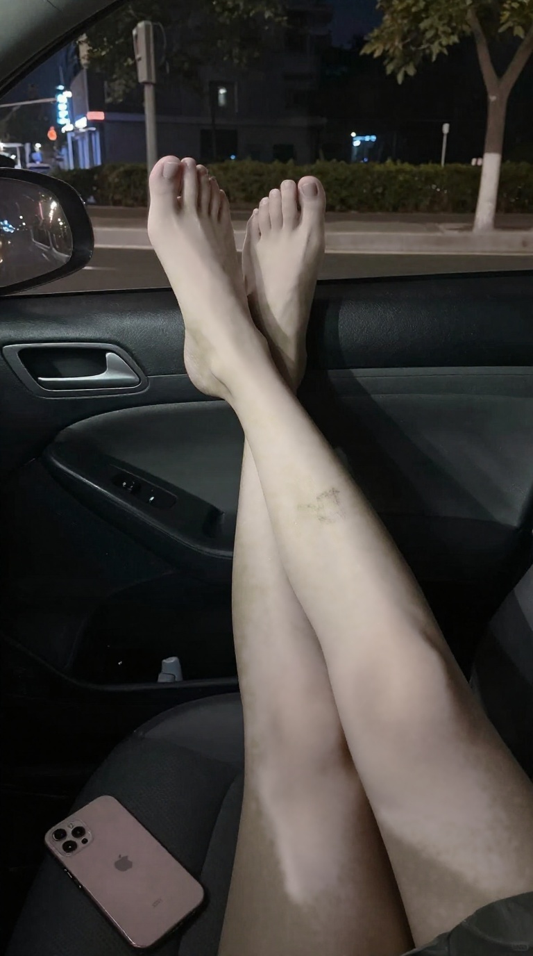 Woman's bare feet in taxi, tattoo on instep, toes splayed, dappled shadows, matte phone case, blurry city lights.